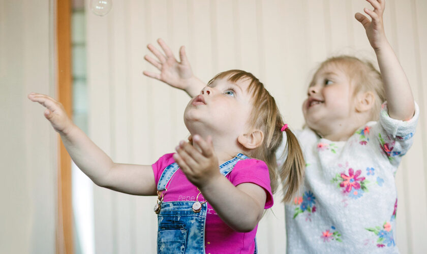 little-girls-catching-soap-bubbles-room